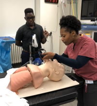 Students intubating mannequin
